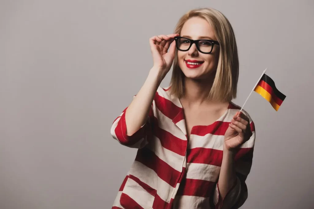 beatiful girl glasses holds german flag